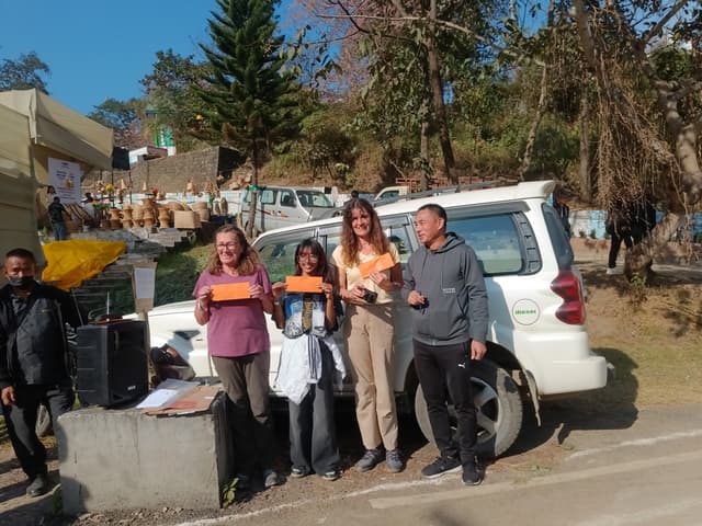 Tourists participate in stilt bamboo race at Naga Heritage Village
