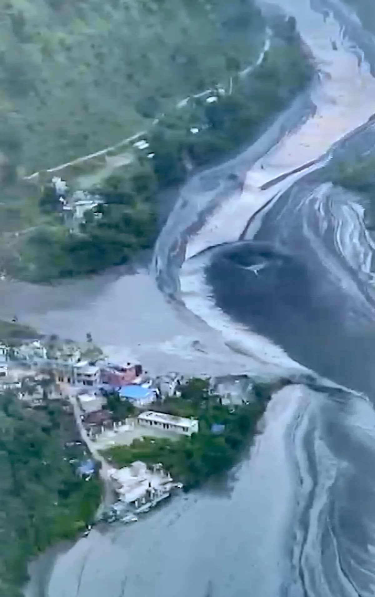 Flash flood sweeps away houses, bridges in Nepal months after deadly disaster.